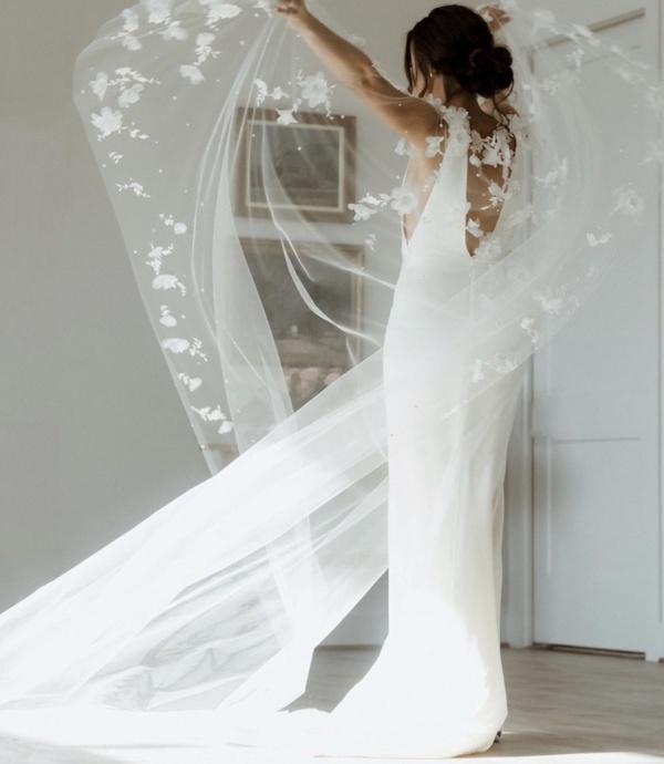 Bride Alex Wears The Draped In Flowers Cape 1.jpg